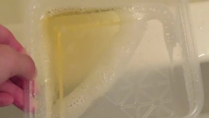 Pissing into the plastic case.