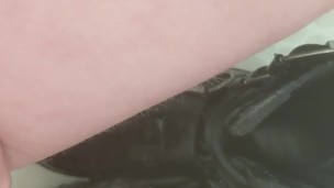 Girl pisses on her black combat boots